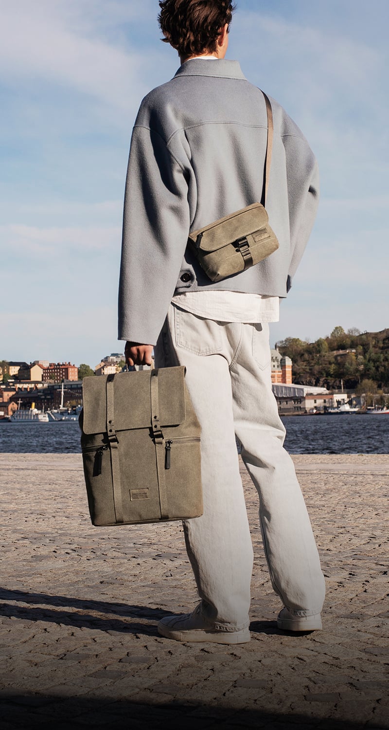 weave backpack and crossbody bag on a model